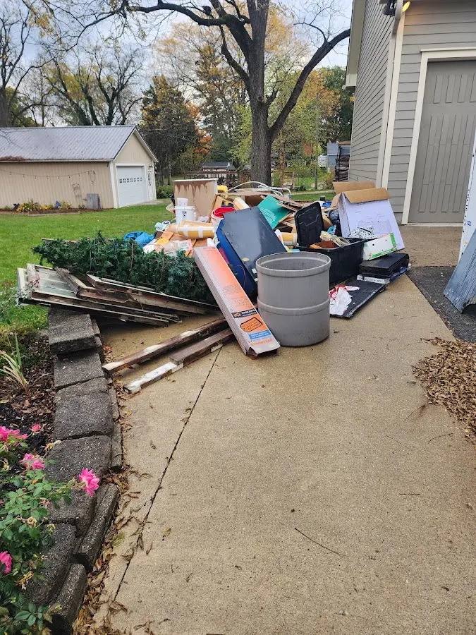 Dumpster being loaded with debris for Roofing Dumpster Rental in Litchfield